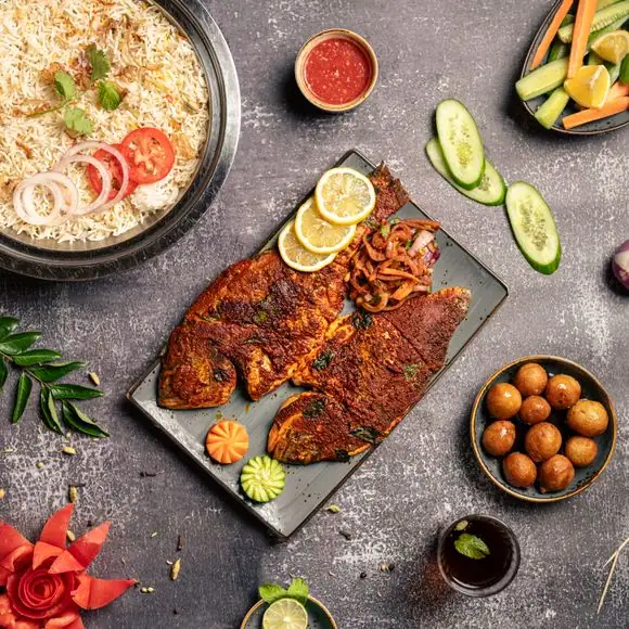 A grand Bengali wedding buffet spread by Food Chakra, featuring traditional curries, dals, and rice dishes served in polished copper handis with brass utensils at a luxury catering venue in Kolkata. | Image for Food Chakra – Trusted Catering Services in Kolkata